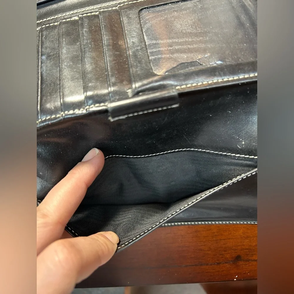 Dooney & Bourke Black Logo Fold Wallet It has a small detail on the inside